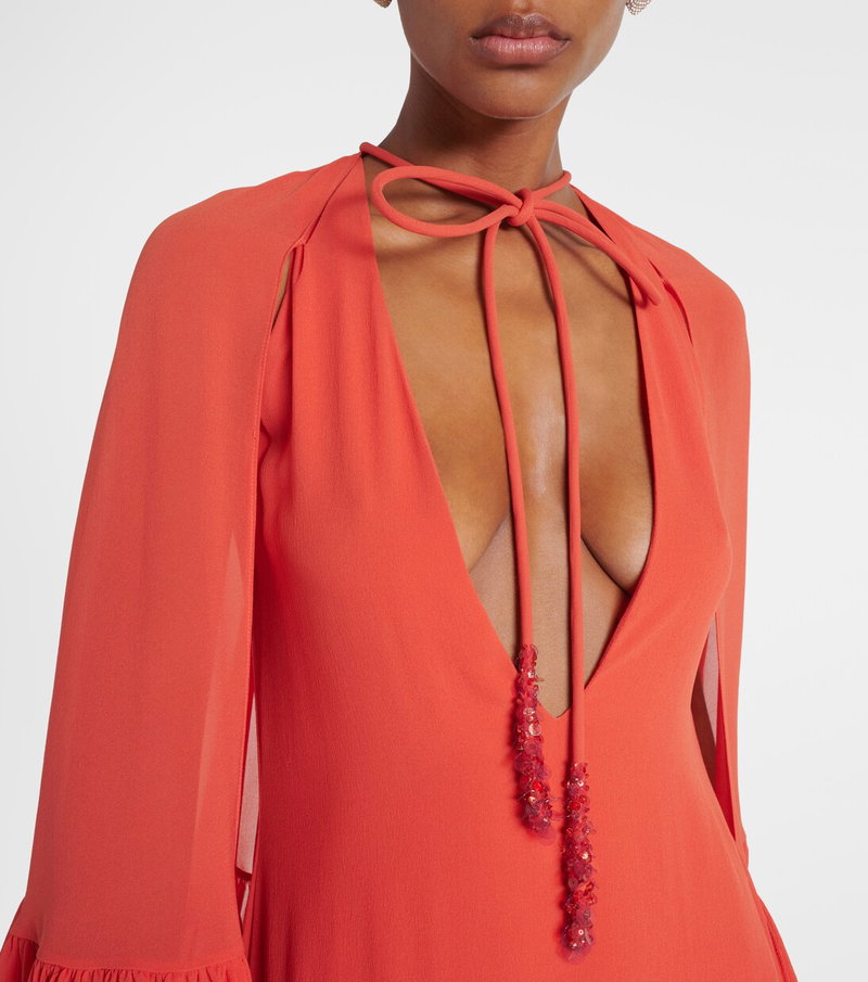 Valentino red chiffon gown with a plunging neckline and beaded tie.