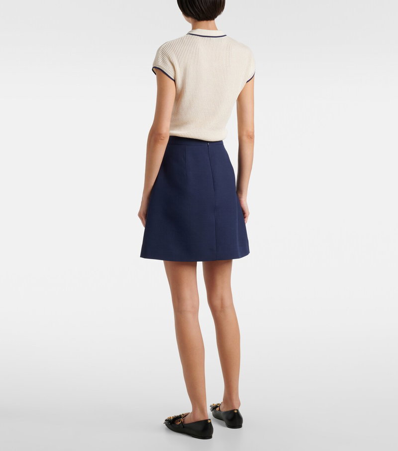 Valentino cream knit sweater with navy mini skirt
