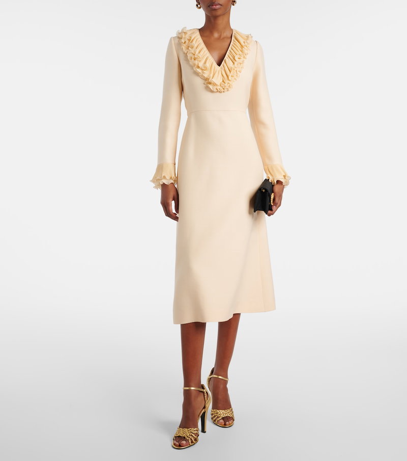 Cream-colored Valentino dress with ruffled neckline.