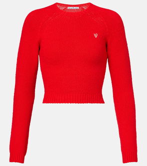 Red, cropped cable-knit sweater with a white logo