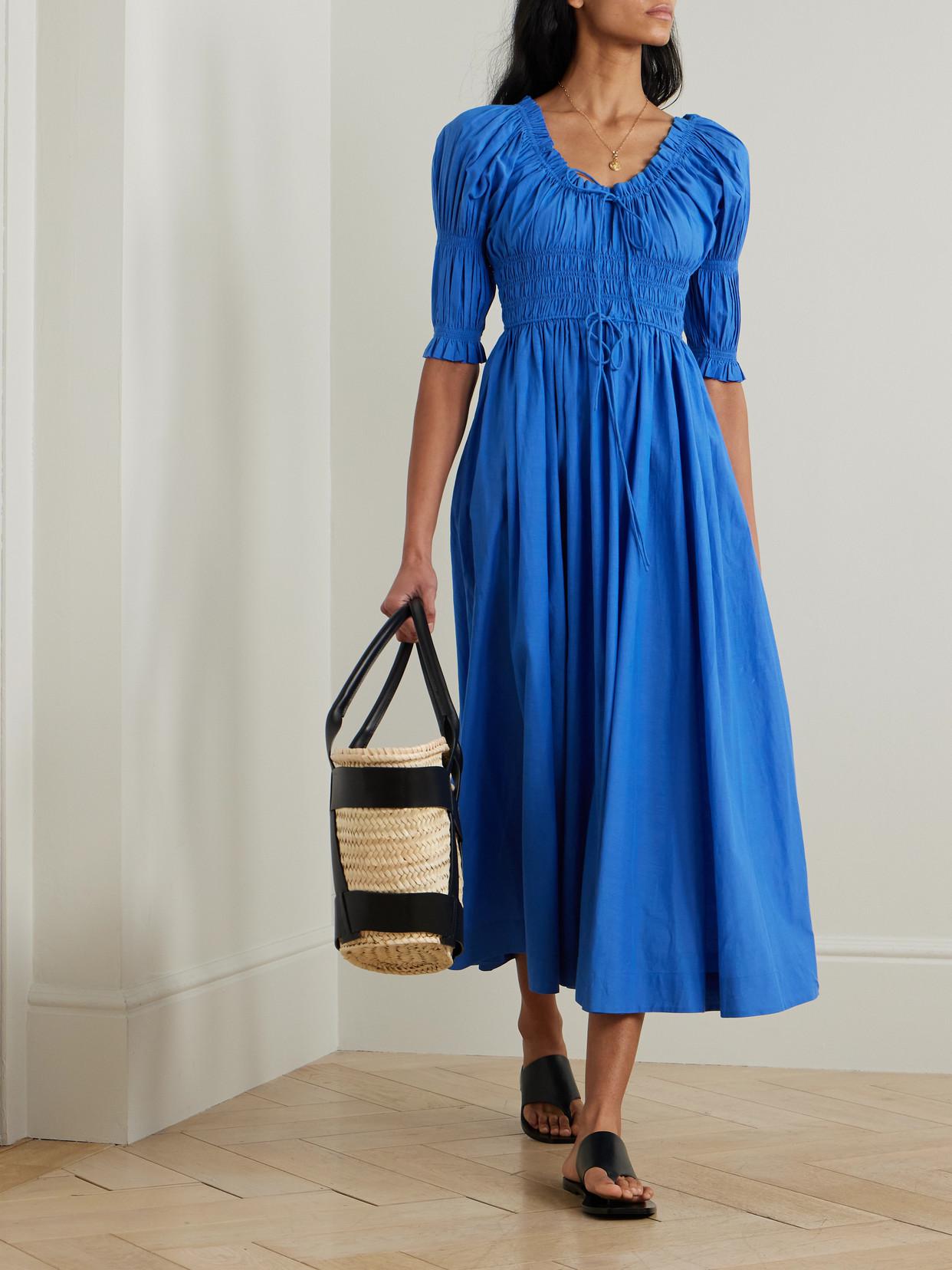 doen ischia dress Women's in white Ruffle Smocked Cotton & Viscose Long Maxi the Ischia Dress is reimagined in a soft organic cotton voile with allover flock dots ITEM: Ischia Dress COLOR: Red