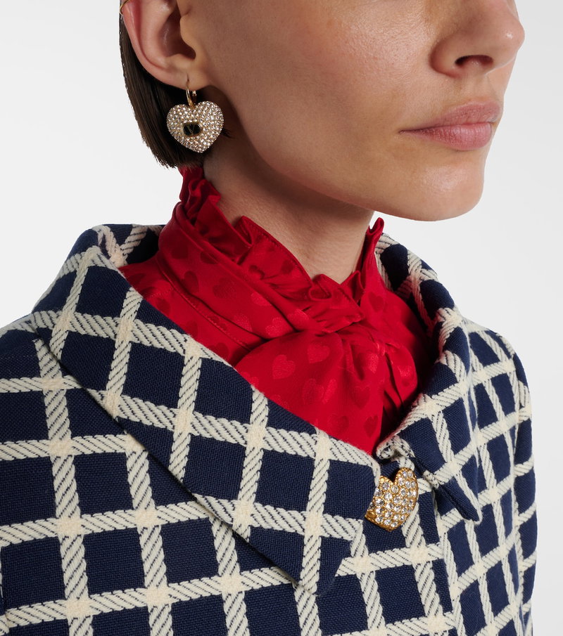 Valentino heart earrings and a red-and-white patterned jacket.