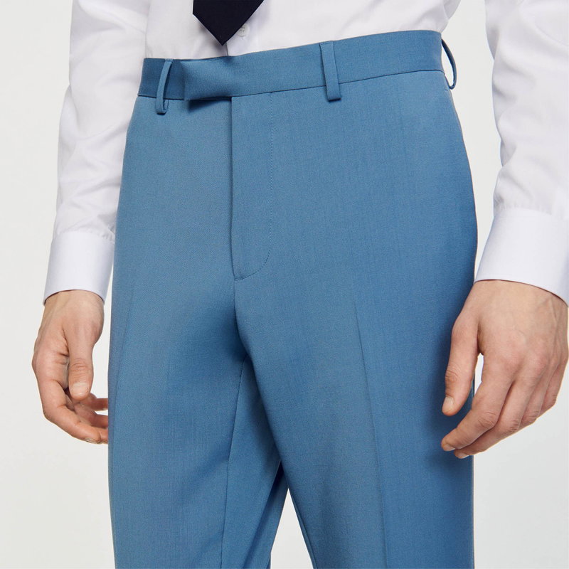 Sandro blue suit trousers, worn by a man