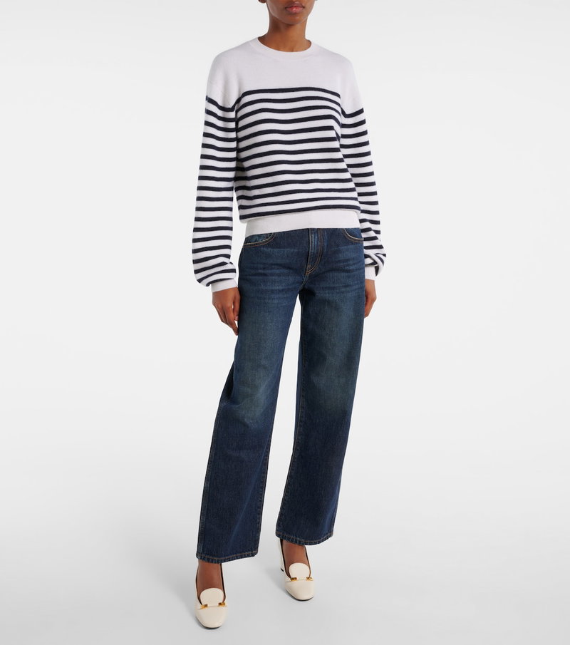 Navy and white striped knit sweater with denim jeans.