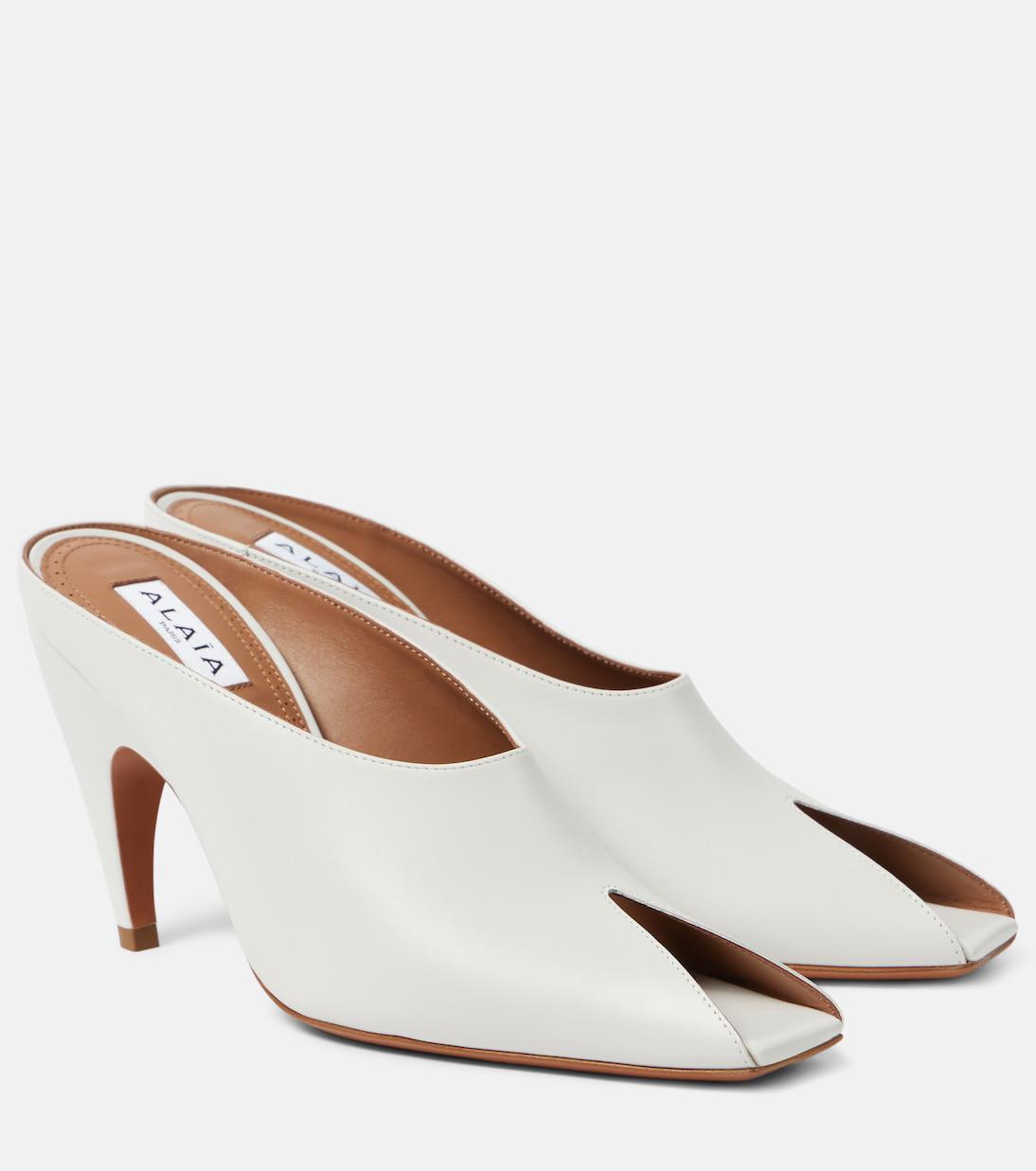 ALAIA SPIKE JEWEL MULES IN BLACK CALFSKIN
