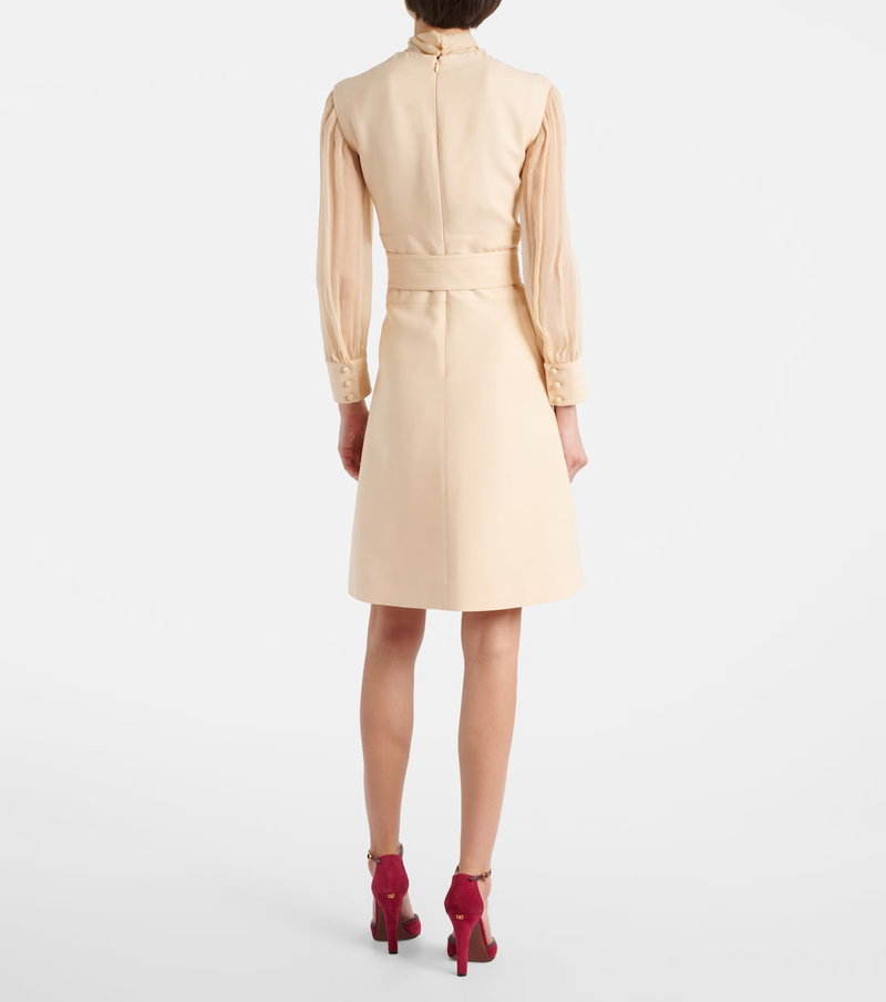 Cream-colored satin dress with long sleeves and a tie belt.