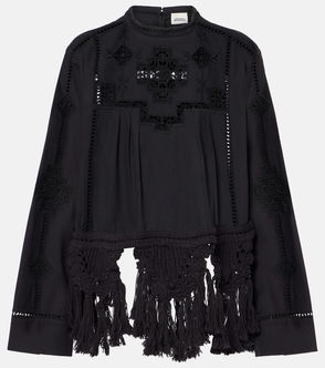 Black blouse with embroidered geometric pattern and fringed sleeves.