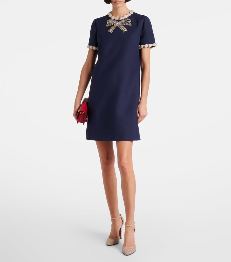 Navy velvet mini dress with a beaded bow detail and matching clutch.