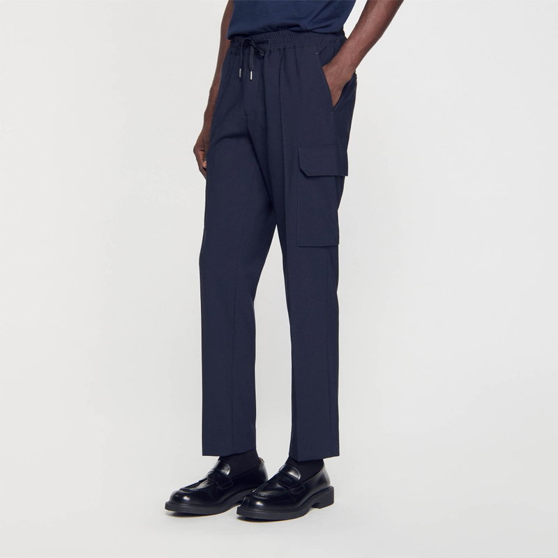 Dark navy cargo trousers with a drawstring waist, worn by a man.