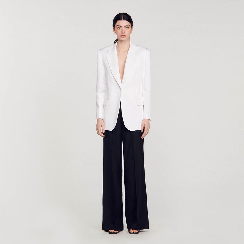 White blazer and black trousers on a model