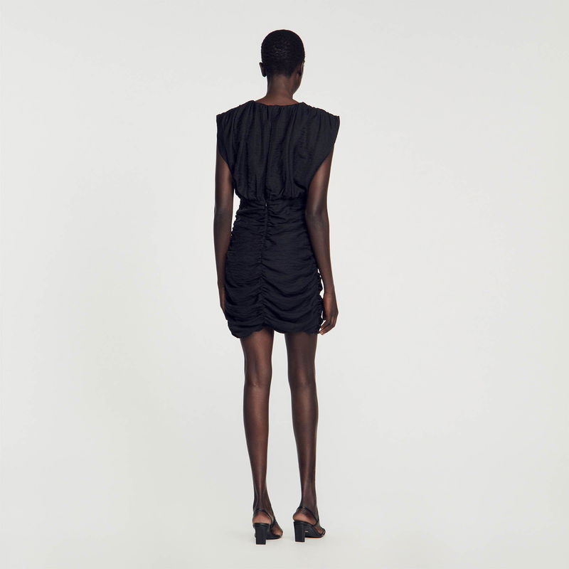 Black ruched mini dress, back view