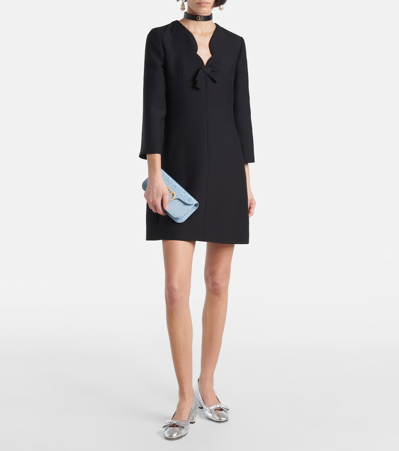 Black Valentino dress with bow neckline and matching clutch.