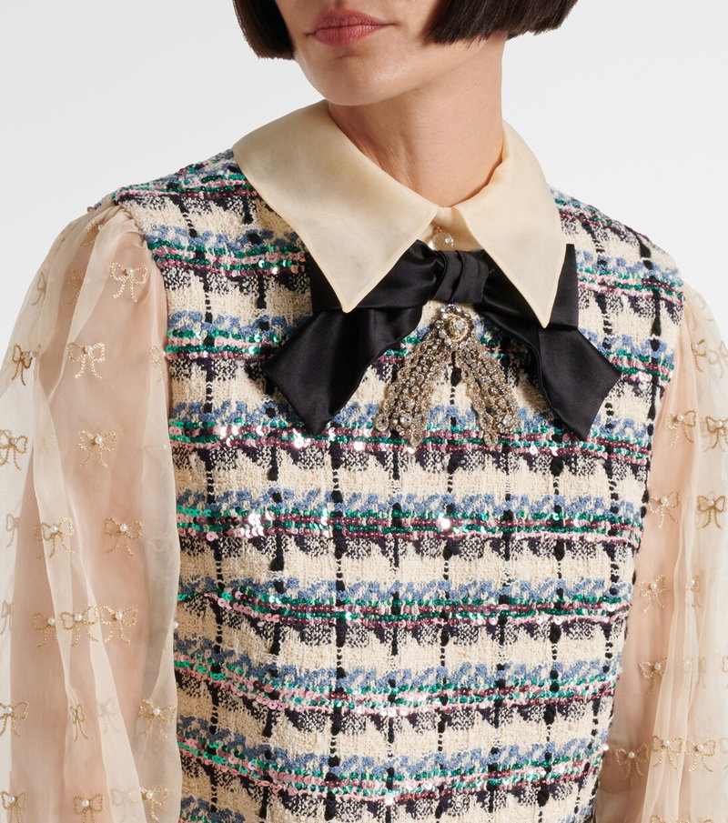 Valentino tweed dress with embellished bow and sheer sleeves.