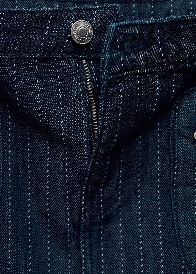 Dark wash denim jeans with white stitching detail