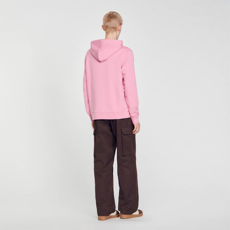 Pink hooded sweatshirt with brown cargo pants.