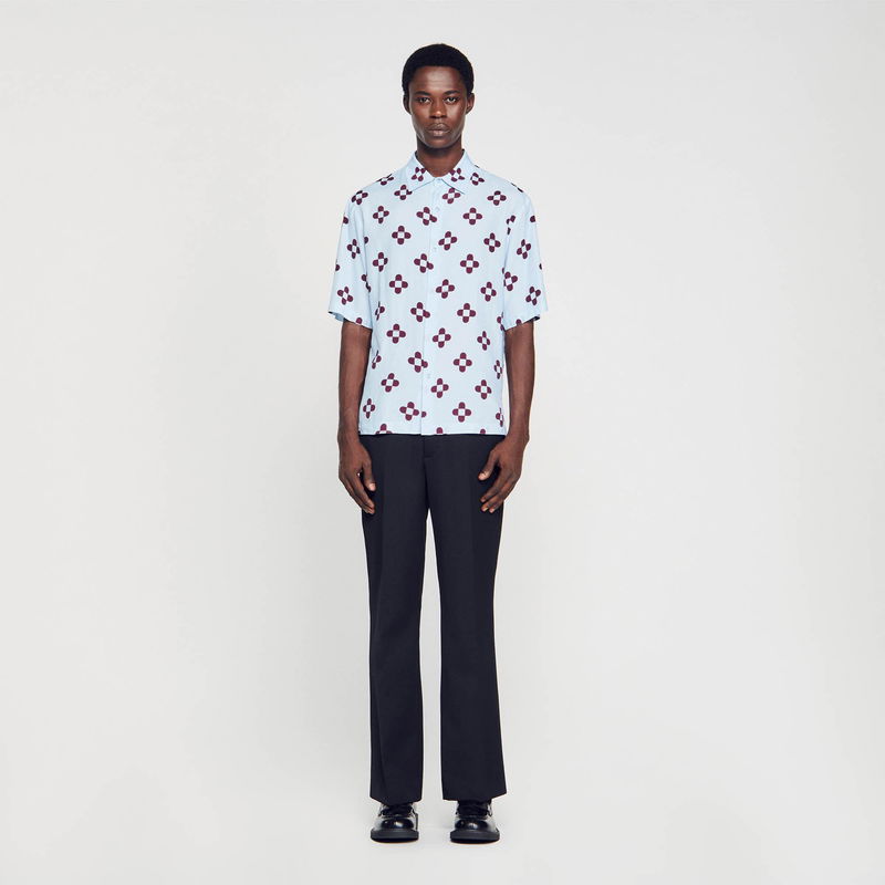 Light blue shirt with maroon floral print, worn by a Black man.