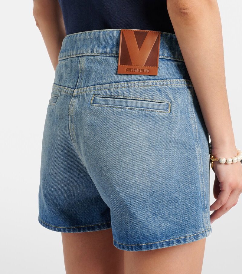 Valentino denim shorts with a brown leather logo patch