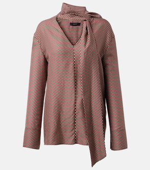 Red and black patterned blouse with a tied neck detail