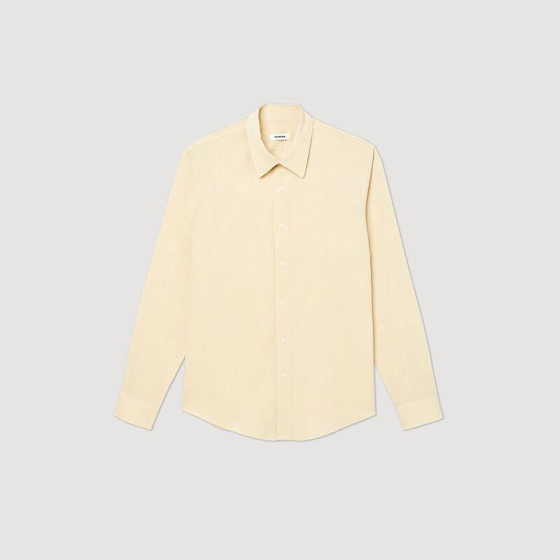 Cream-colored linen shirt, buttoned, with long sleeves.