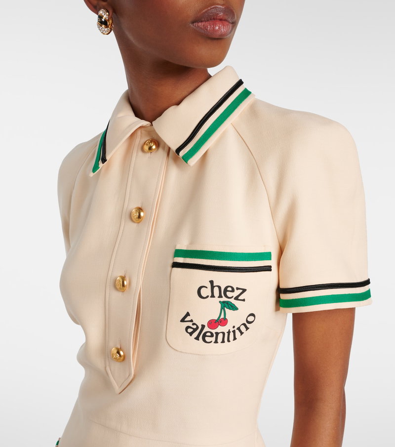 Cream polo shirt with green stripes and cherry logo
