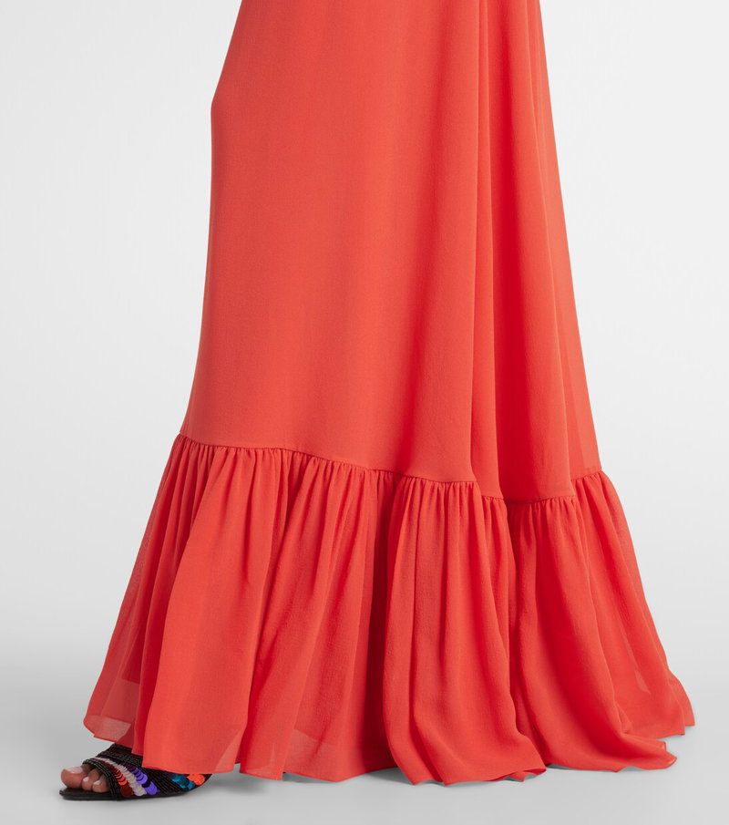 Valentino maxi dress in vibrant red chiffon, featuring a tiered, ruffled hem.