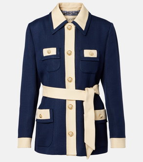 Dark blue blazer with cream-colored collar and cuffs, featuring gold buttons and a tie belt.