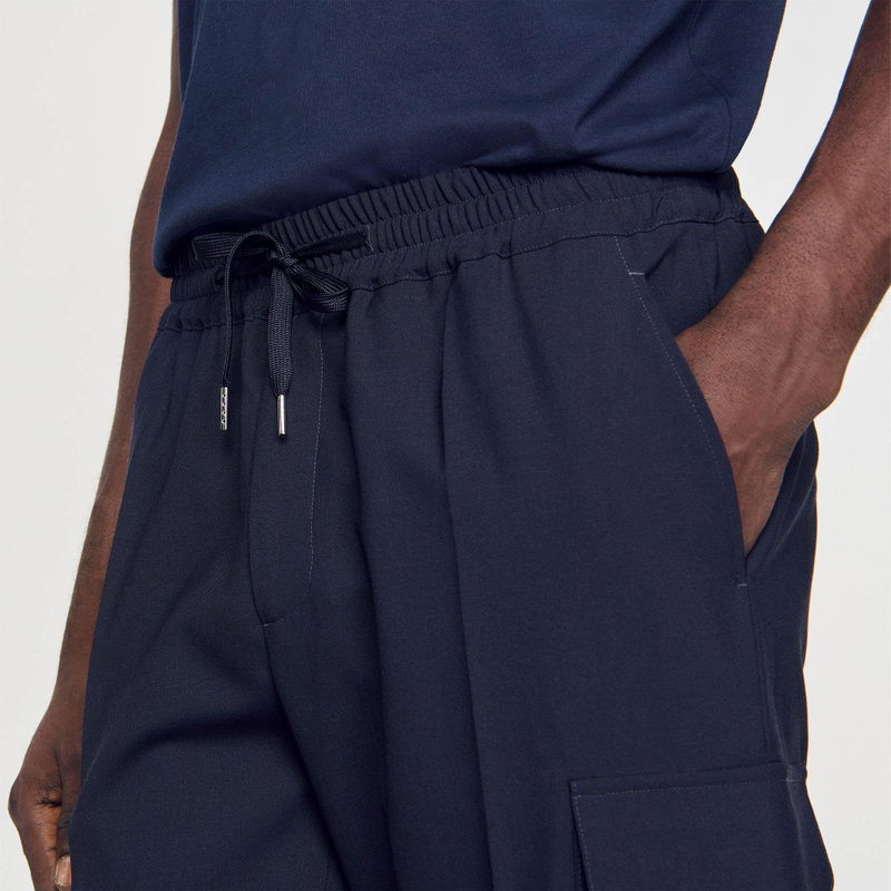Dark navy SANDRO joggers with drawstring waist and pockets.