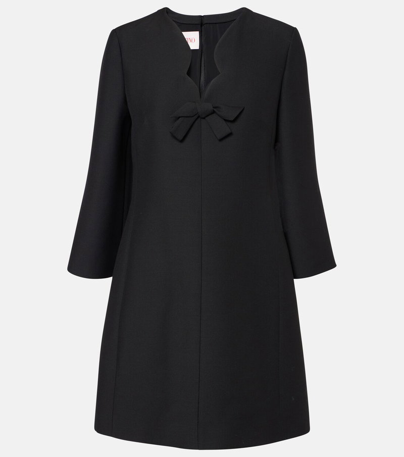 Black Valentino sheath dress with a red bow detail.