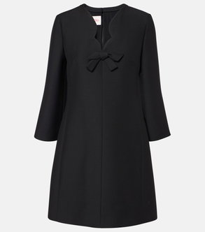 Black Valentino sheath dress with a red bow detail.