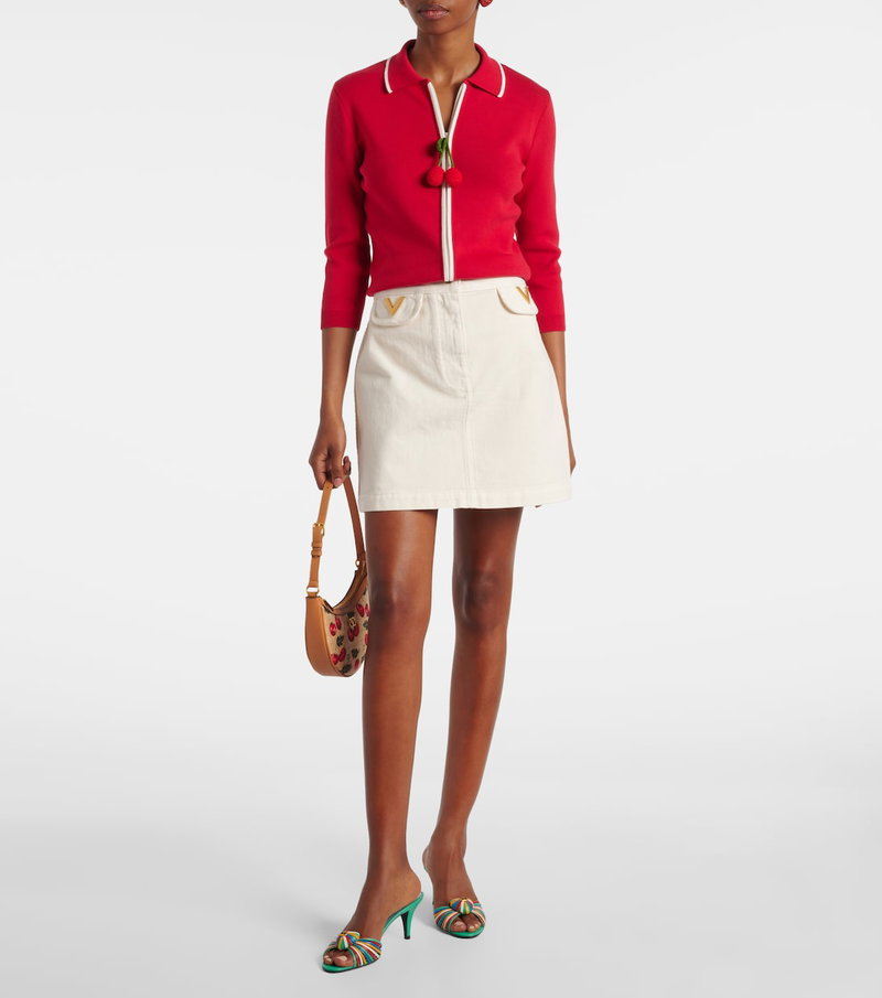 Valentino woman in red and white cardigan and skirt