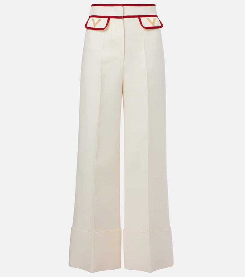 Cream wide-leg trousers with red trim and Valentino logo.