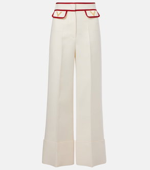 Cream wide-leg trousers with red trim and Valentino logo.