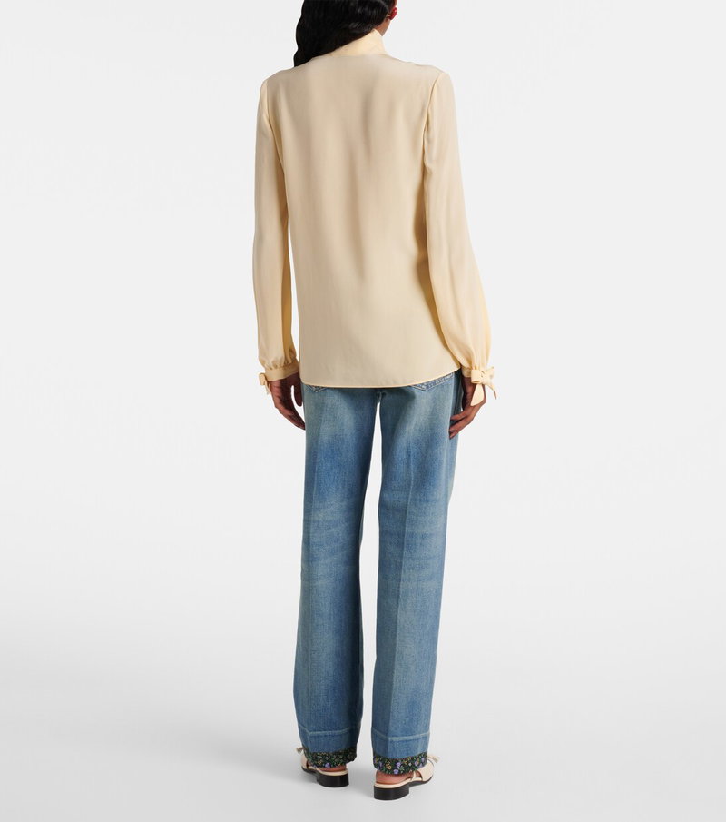 Valentino cream silk blouse with tied sleeves.