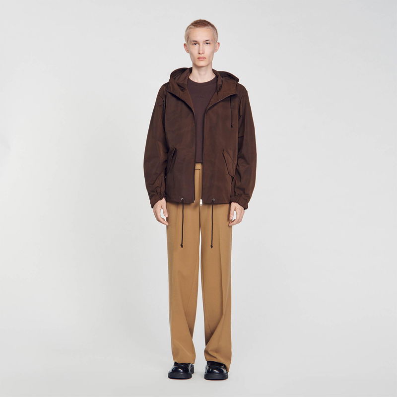 SANDRO - Brown hooded jacket with model wearing trousers and shoes.