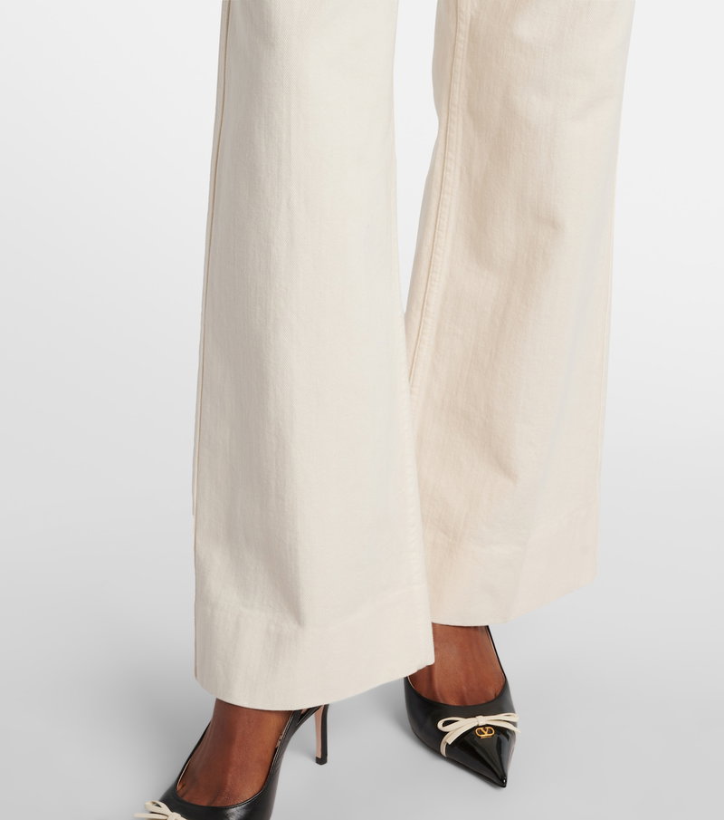 Valentino wide-leg, cream-colored denim trousers with gold logo detail.