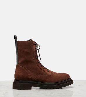 Brown suede lace-up combat boot on marble surface