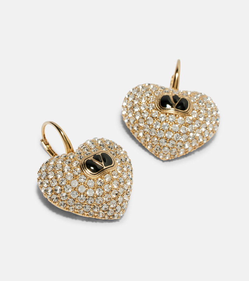 Gold heart-shaped earrings adorned with rhinestones.