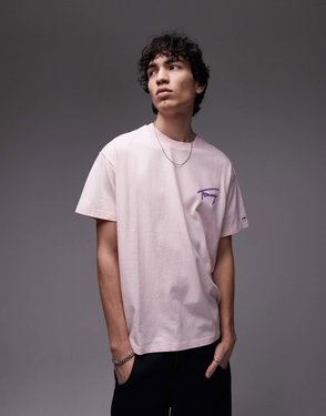 Tommy Jeans pink t-shirt with a purple koi fish graphic, worn by a young man.