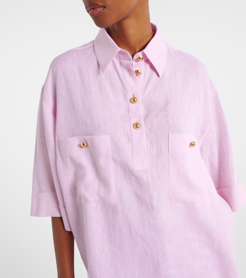 Pink linen shirt with gold buttons, close-up shot