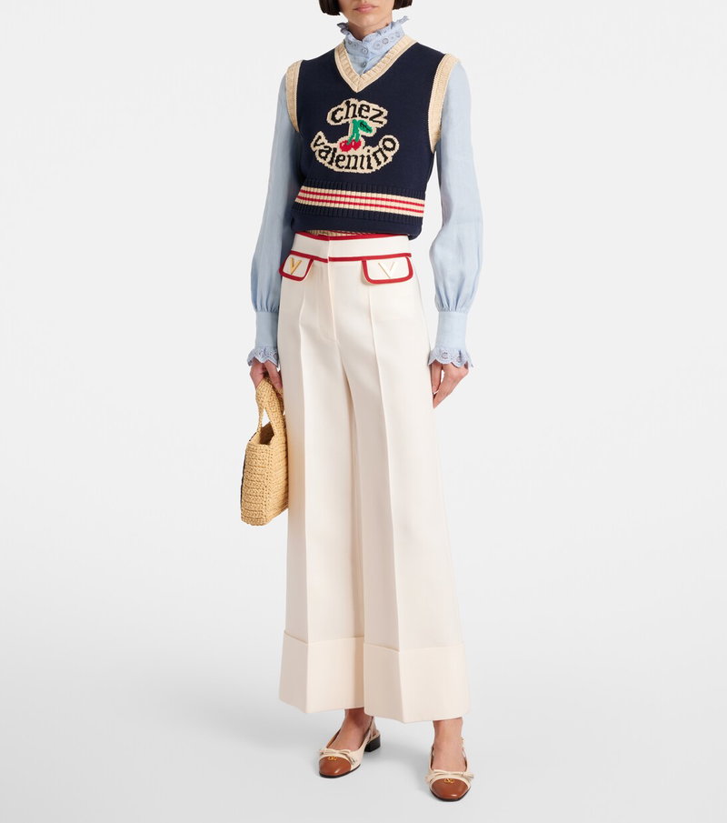 Valentino sweater, pants, and handbag ensemble with cherry emblem.