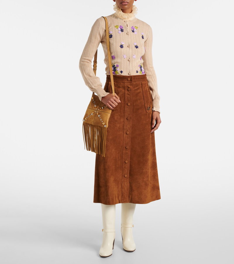 Valentino ribbed sweater with floral embroidery, suede skirt, and crossbody bag