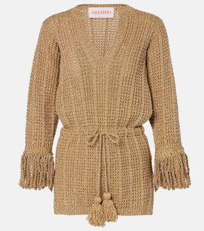 Gold knitted wrap dress with fringed sleeves and drawstring tie.