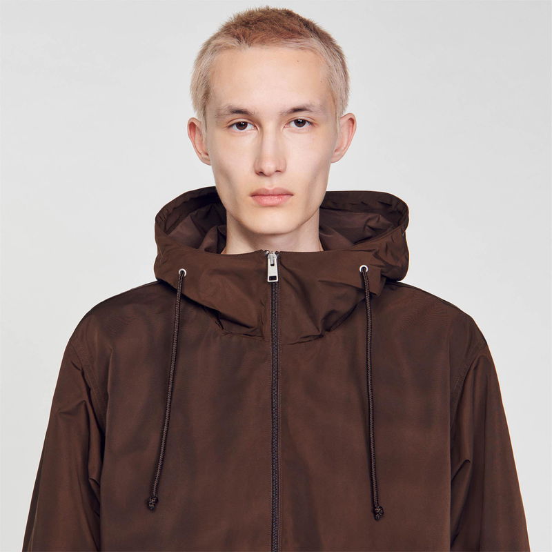 Brown hooded jacket on a young man.