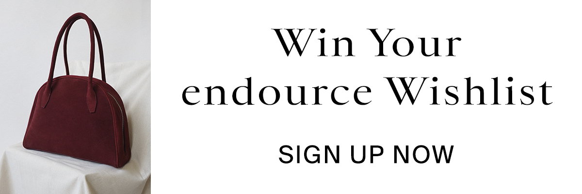 Flower in perfume bottle, red handbag