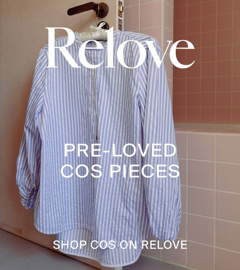 Blue and white striped shirt in pink-tiled bathroom